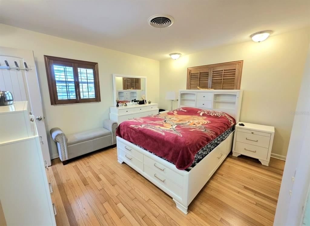 6736 Ralston Beach Circle Tampa, FL 33614 - Photo 28 of 37 a bedroom with a bed and wooden floor