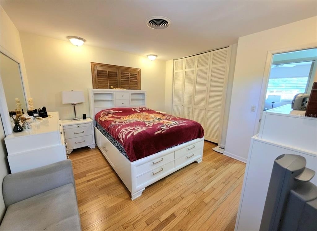 6736 Ralston Beach Circle Tampa, FL 33614 - Photo 30 of 37 a spacious bedroom with a bed and a couch