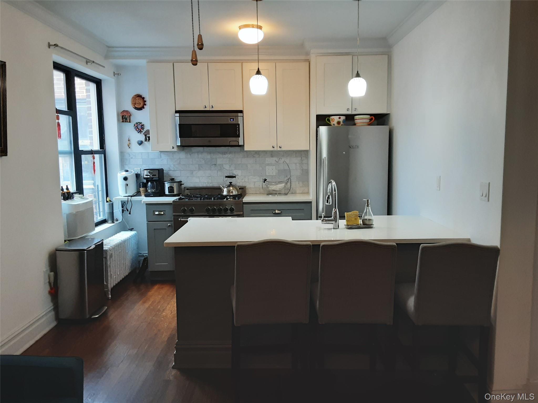42-22 Ketcham Street, Unit F16 Queens, NY 11373 - Photo 1 of 17 a kitchen with a sink cabinets and microwave