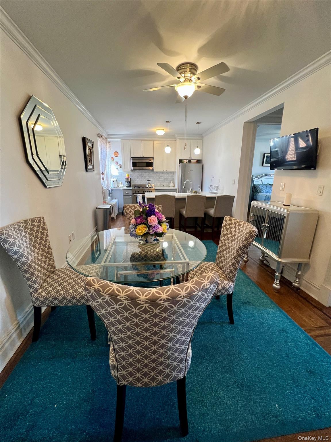 42-22 Ketcham Street, Unit F16 Queens, NY 11373 - Photo 2 of 17 a living room with furniture and flat screen tv