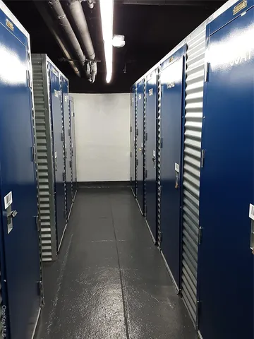 a living room with furniture and a mirror