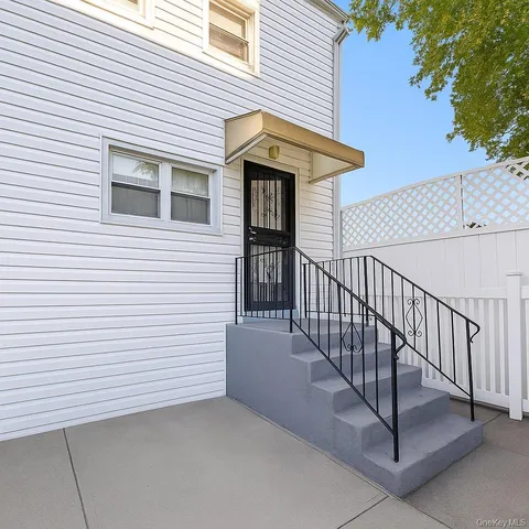 a view of a house with wooden fence