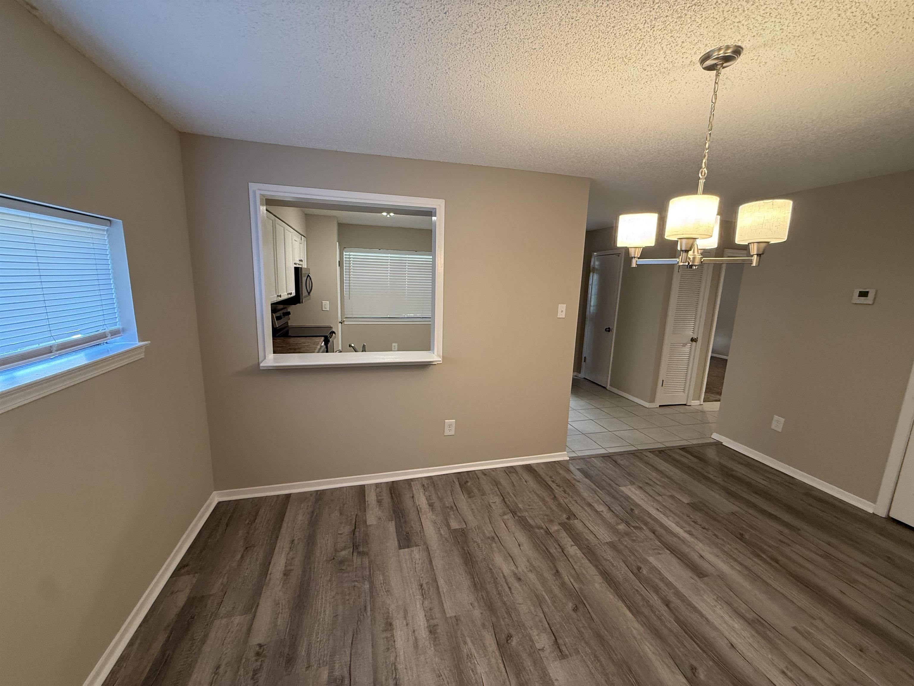 3084 Rising Sun Road, Unit 68 Lakeland, TN 38002 - Photo 12 of 13 Updated flooring throughout, neutral paint finishes, and a kitchen pass-through window with white trim