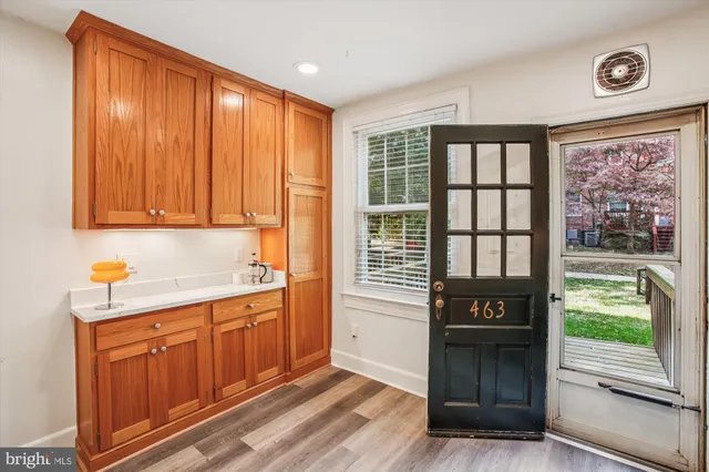 a view of a kitchen with a sink dishwasher and wooden cabinets