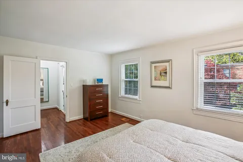 a bedroom with a bed and a night stand