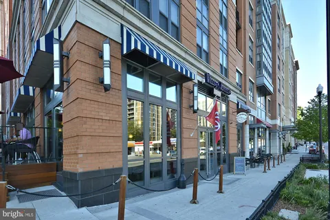 a view of a brick house with a swimming pool and a chairs