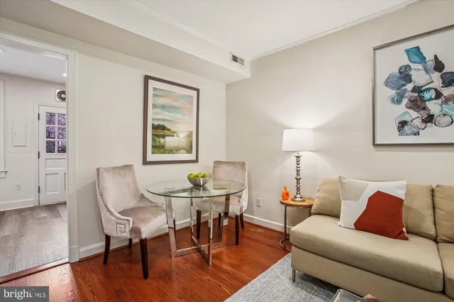 a kitchen with stainless steel appliances granite countertop a refrigerator a sink dishwasher and wooden cabinets with wooden floor