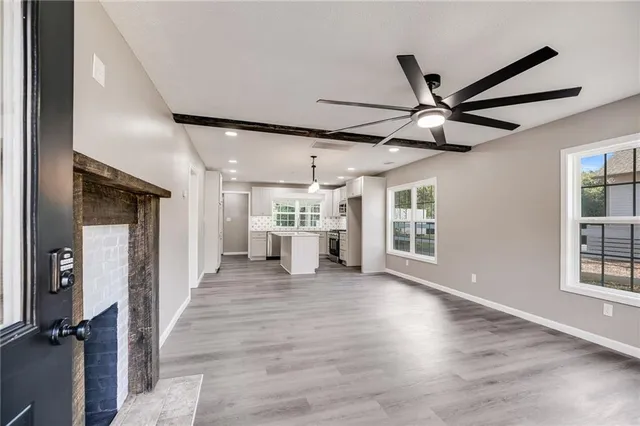 a view of a livingroom with a ceiling fan and window
