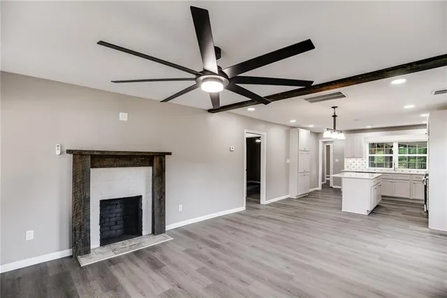 a view of a kitchen with a fireplace and wooden floor