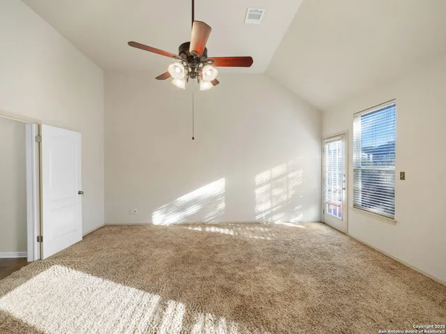 a view of a livingroom with a ceiling fan and window