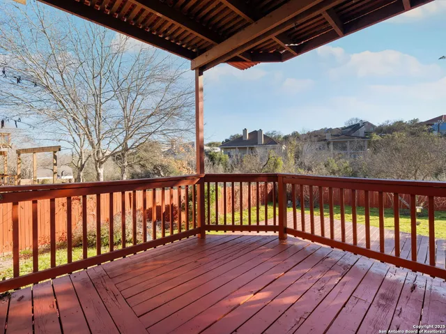 a view of wooden balcony with a lake