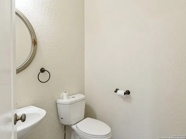 a white toilet sitting next to a bathroom sink
