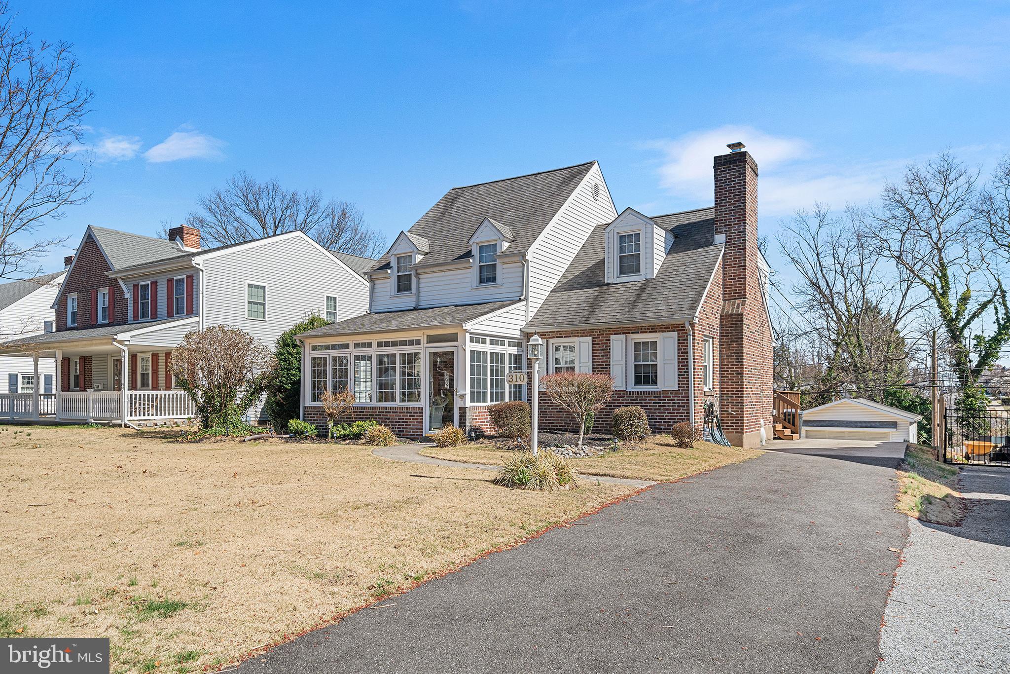 a front view of multiple houses with yard