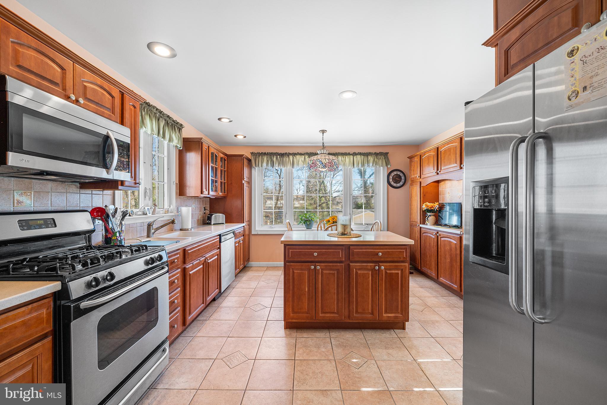 310 Manor Circle Folsom, PA 19033 - Photo 11 of 31 a large kitchen with stainless steel appliances granite countertop a stove a sink and a refrigerator