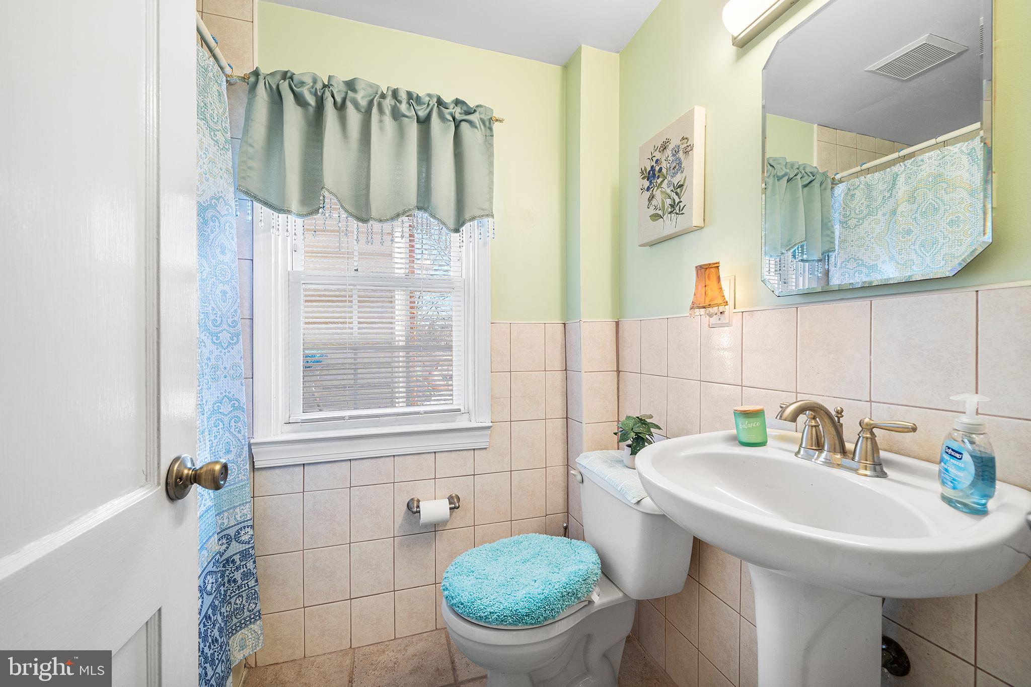 310 Manor Circle Folsom, PA 19033 - Photo 15 of 31 a bathroom with a sink a toilet and a mirror