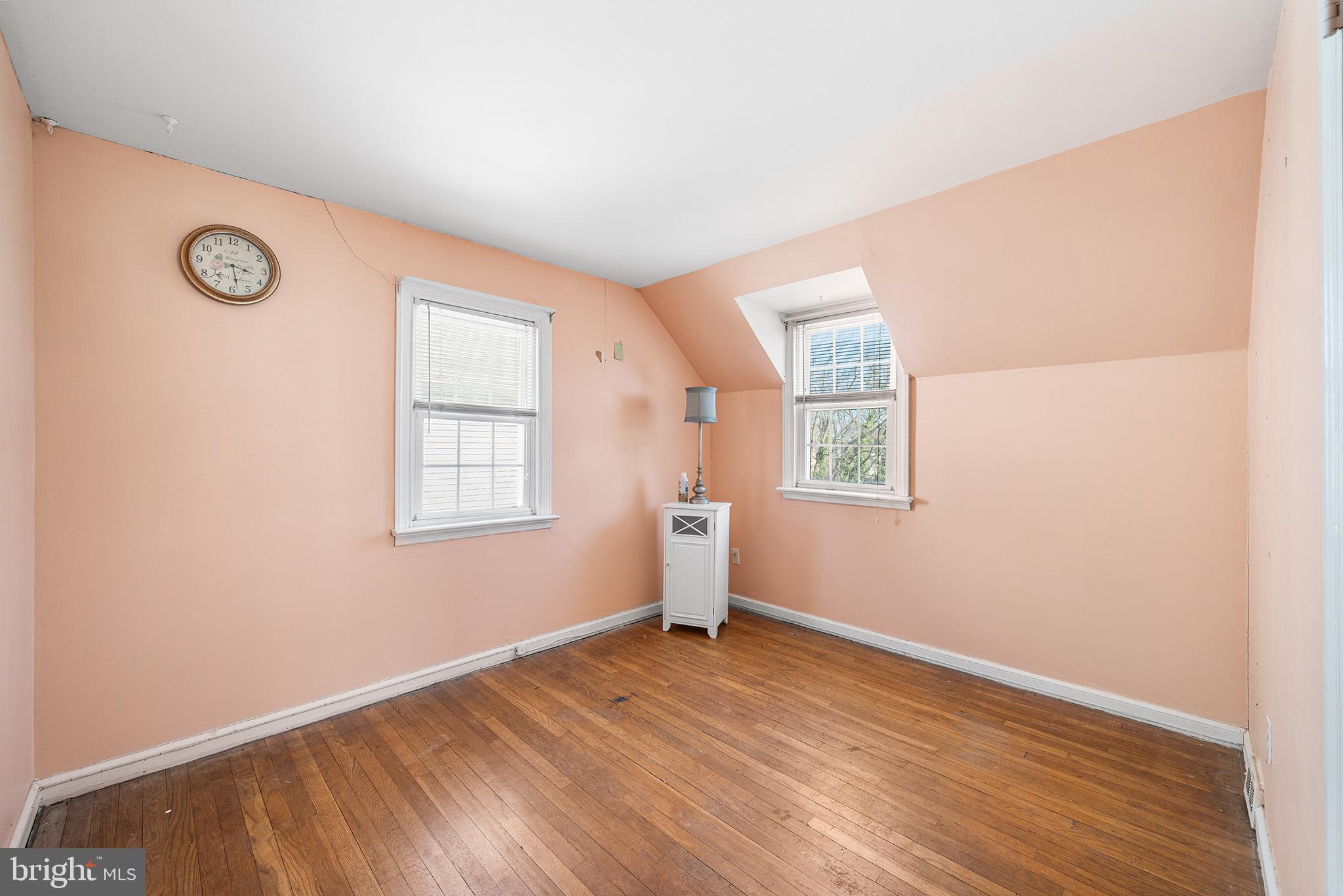 310 Manor Circle Folsom, PA 19033 - Photo 16 of 31 an empty room with wooden floor and windows