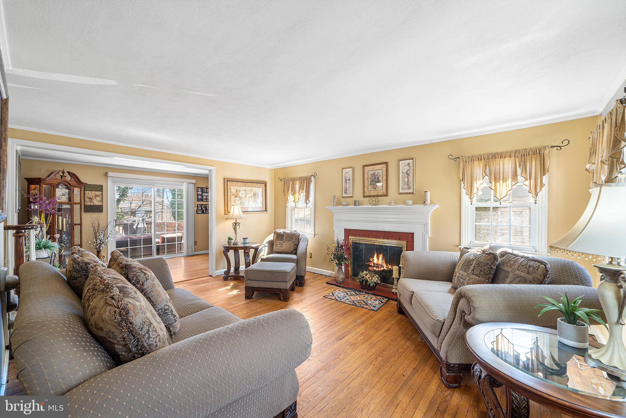 310 Manor Circle Folsom, PA 19033 - Photo 7 of 31 a living room with furniture fireplace and a large window