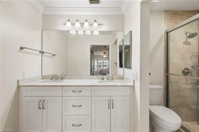 a bathroom with a granite countertop sink a toilet and a mirror