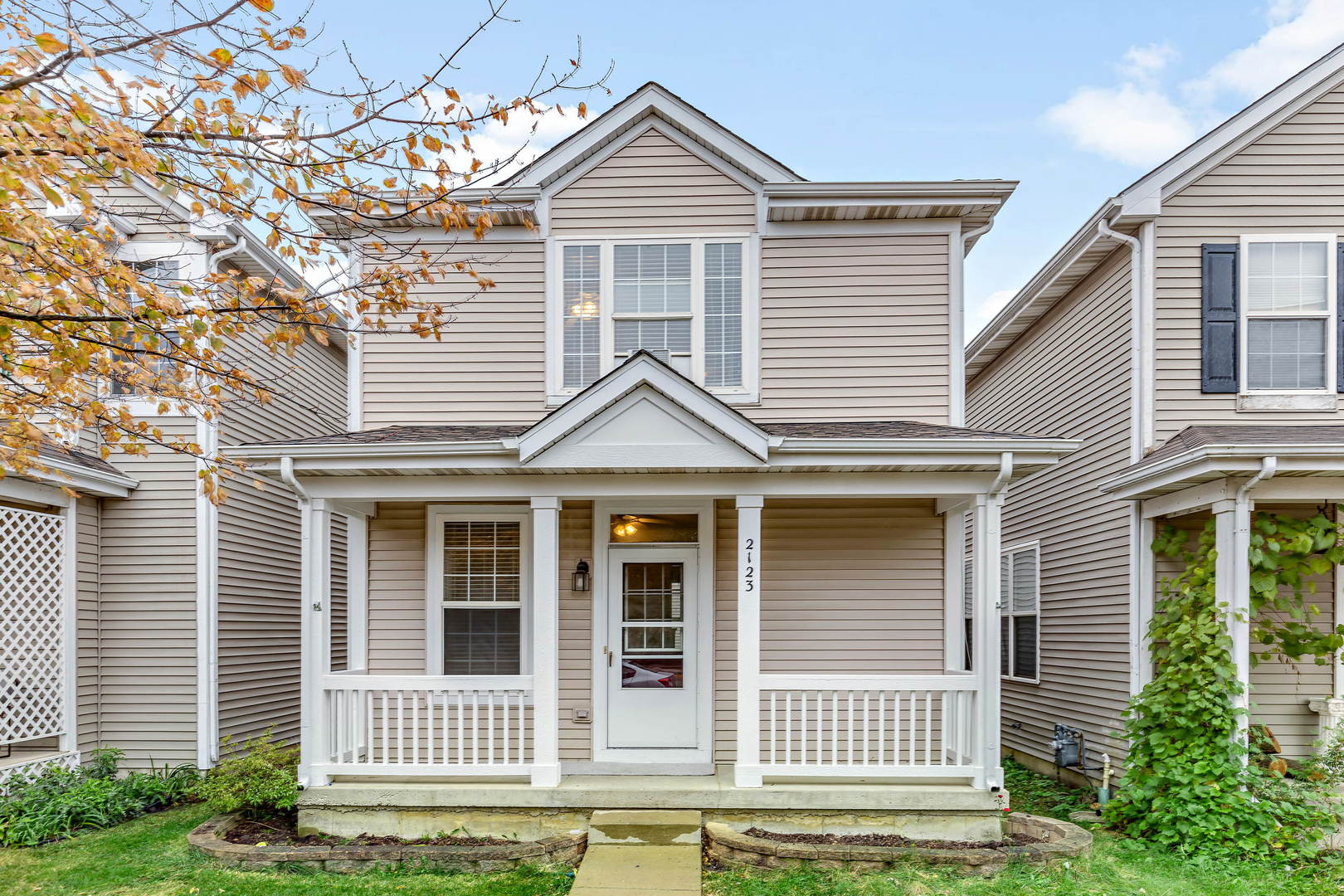 a view of a house with a window and wooden fence