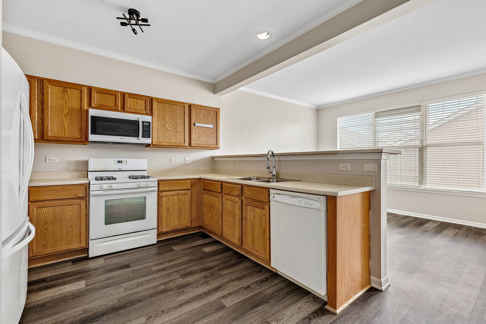 2123 Grayhawk Drive Aurora, IL 60503 - Photo 6 of 18 a kitchen with stainless steel appliances granite countertop a stove and a sink