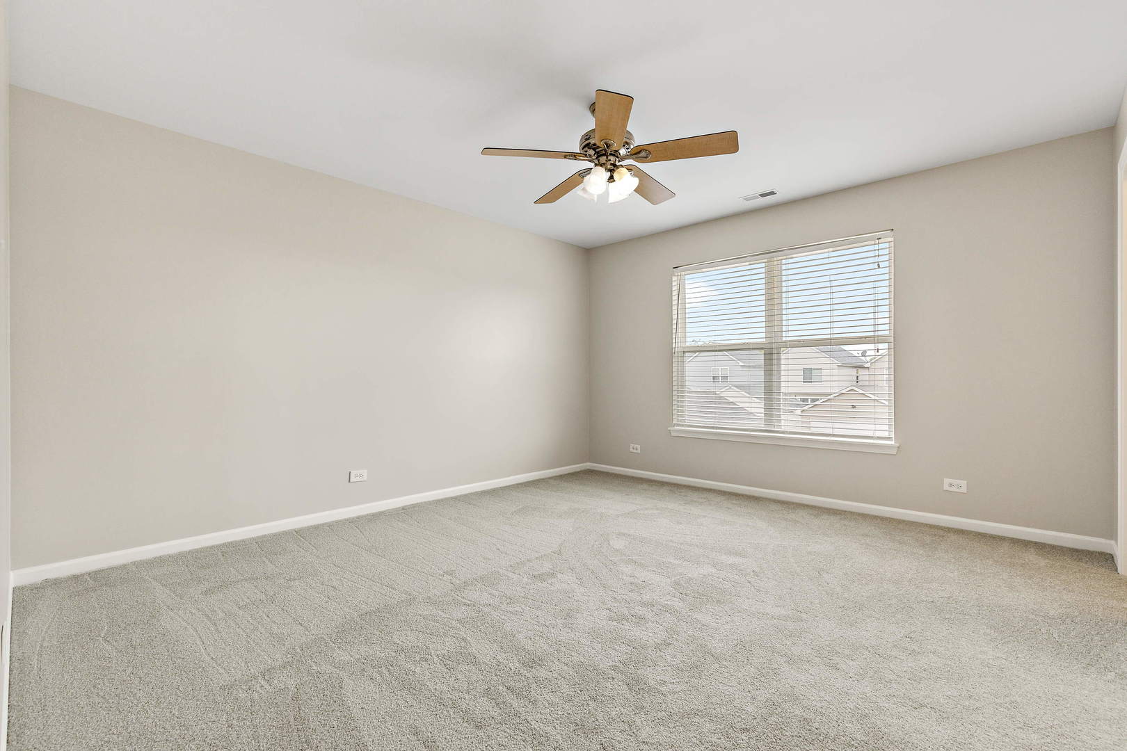 2123 Grayhawk Drive Aurora, IL 60503 - Photo 10 of 18 an empty room with windows and fan