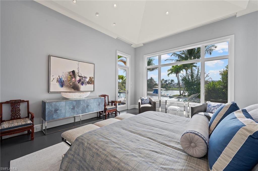 1779 Crayton Road Naples, FL 34102 - Photo 17 of 18 a bedroom with bed and glass windows