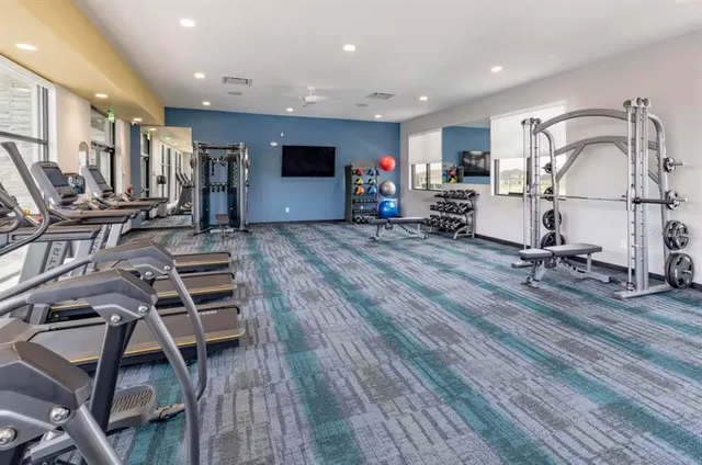 an aerial view of a house with swimming pool and outdoor seating