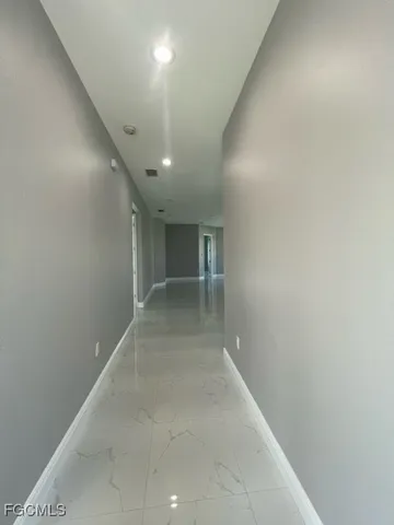 an empty room with a empty space and windows