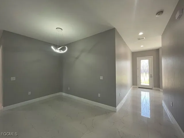 a open kitchen with white cabinets and stainless steel appliances