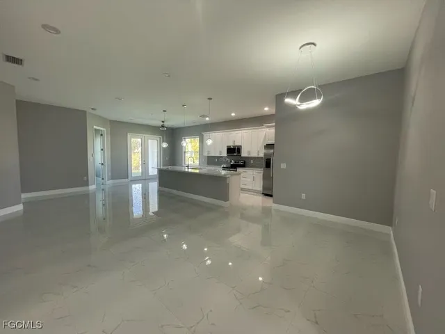 a view of an empty room with a window