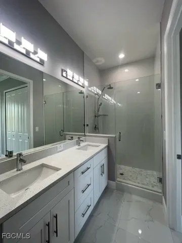 a bathroom with a granite countertop sink toilet a mirror and shower