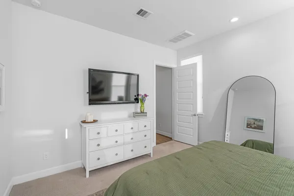 a bedroom with a bed and flat screen tv