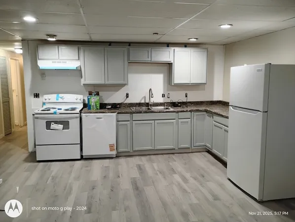 a kitchen with stainless steel appliances granite countertop a stove a sink dishwasher and a refrigerator