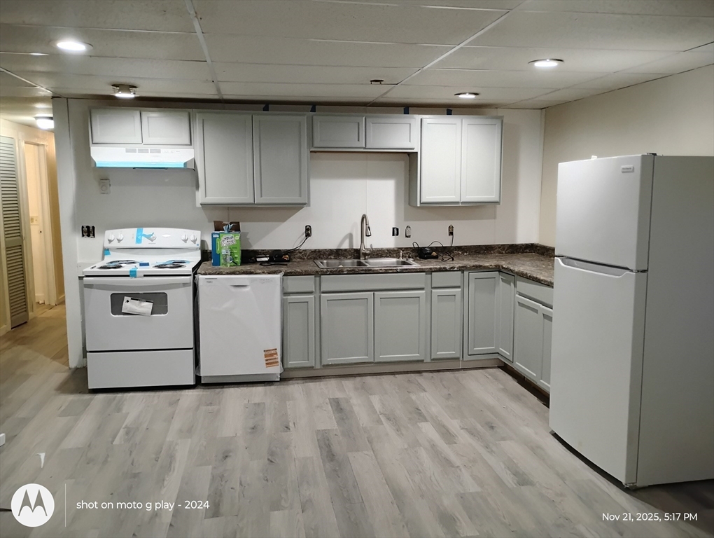 a kitchen with stainless steel appliances granite countertop a stove a sink dishwasher and a refrigerator