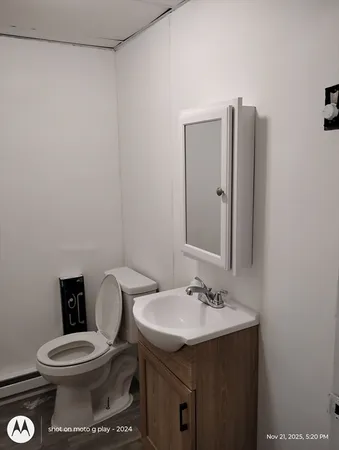 a bathroom with a toilet sink and mirror