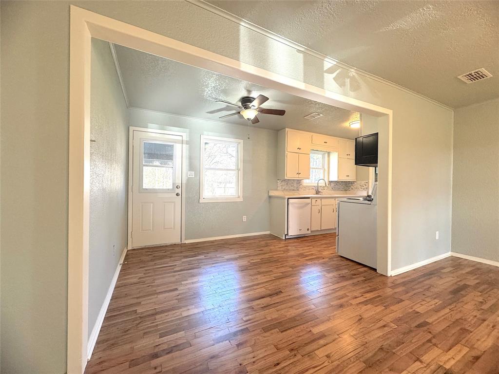 281 Lake Drive Mount Vernon, TX 75457 - Photo 2 of 13 a view of a big room with wooden floor and a kitchen