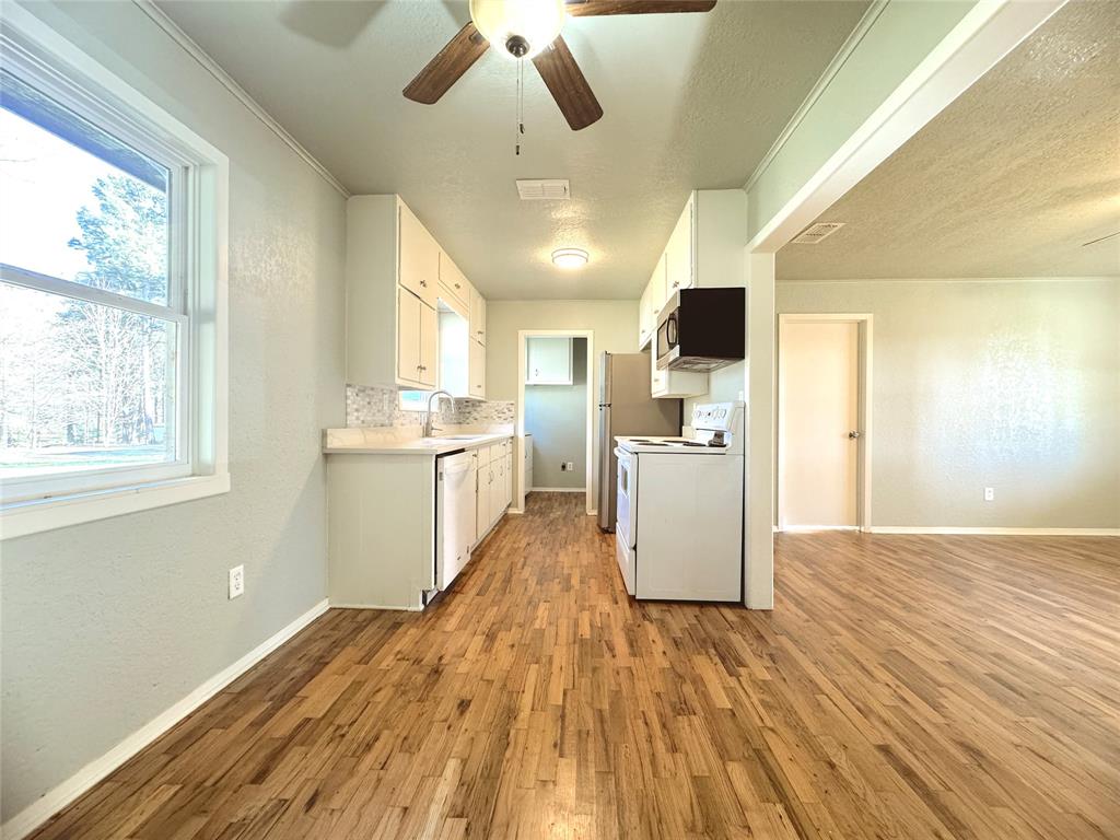 281 Lake Drive Mount Vernon, TX 75457 - Photo 3 of 13 a kitchen with stainless steel appliances granite countertop a stove and a refrigerator