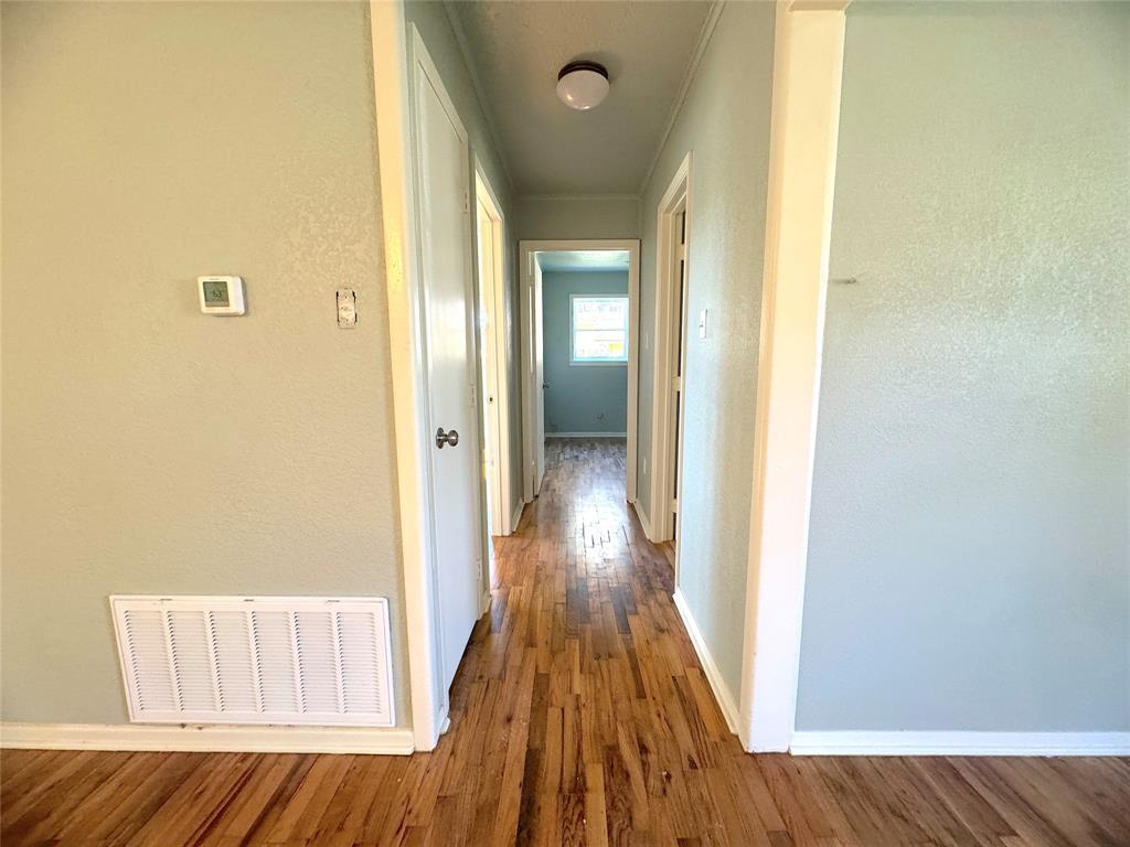 281 Lake Drive Mount Vernon, TX 75457 - Photo 9 of 13 a view of a room with wooden floor and a bathroom