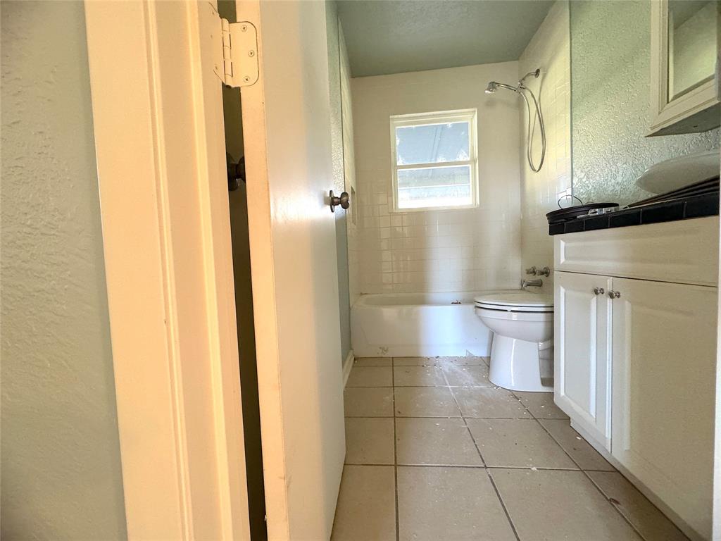 281 Lake Drive Mount Vernon, TX 75457 - Photo 10 of 13 a bathroom with a granite countertop toilet and a shower