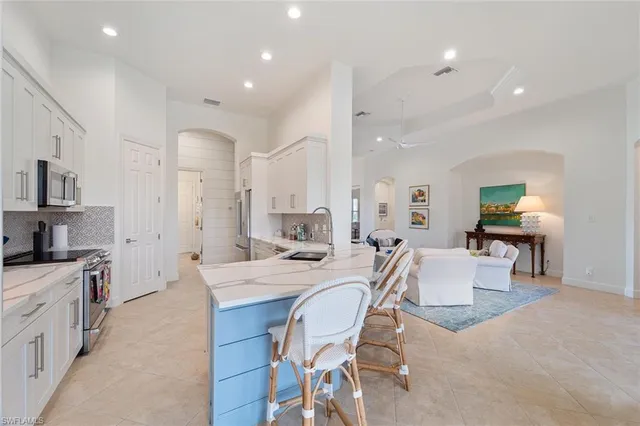 a large kitchen with a table and chairs
