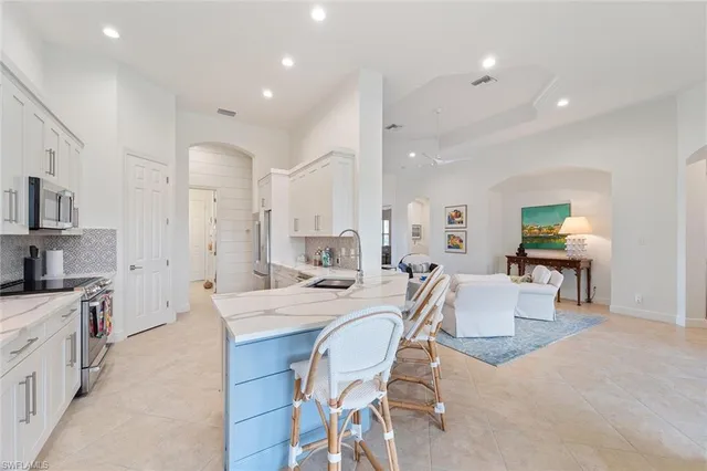 a large kitchen with a table and chairs