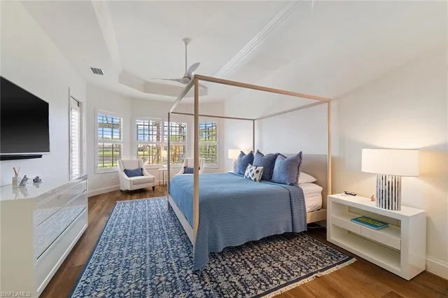 a room with a bed and a flat screen tv