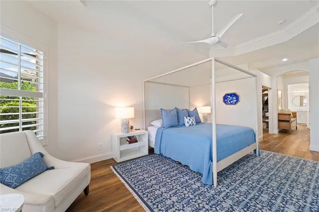 a bedroom with a large bed and a window