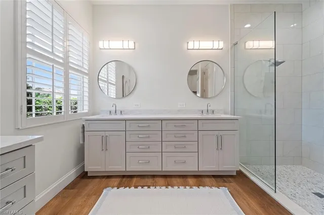 a bathroom with a double vanity sink and a mirror