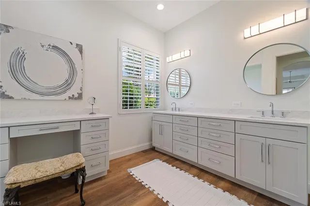 a spacious bathroom with a double vanity sink and a mirror