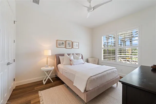 a bedroom with a bed and a desk