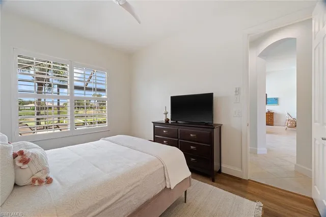 a bedroom with a bed and a television