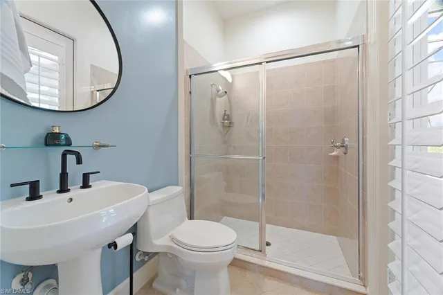 a bathroom with a sink toilet and a mirror