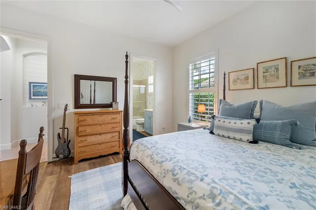 a bedroom with a large bed and a dresser