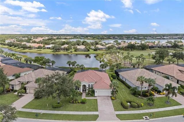an aerial view of lake and residential houses with outdoor space